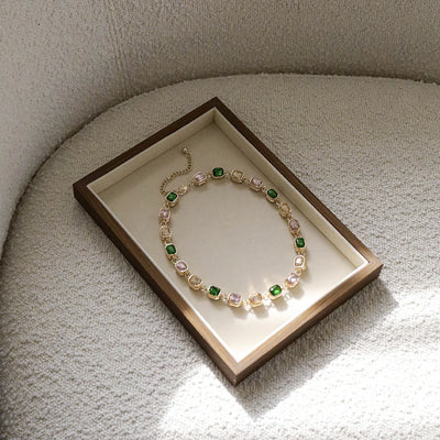 Everyday luxury Rosalie Necklace flatlay – emerald-cut glass stones in gold setting