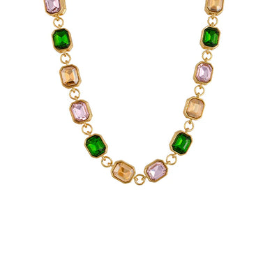 Rosalie Necklace flatlay – emerald-cut glass stones in gold setting